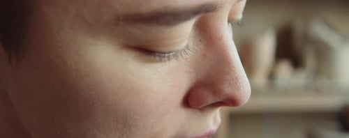 Young Adult Shaping Clay with Tool Close Up
