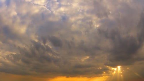 Majestic Cloudscape at Sunset with Golden Light Rays