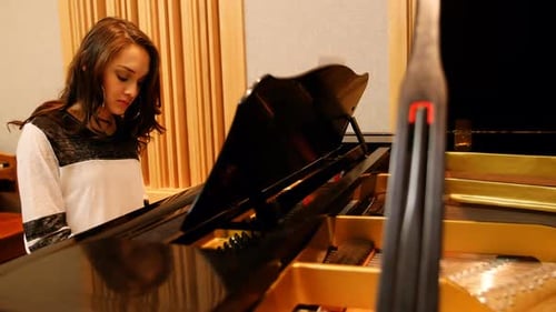 Young Woman Plays Grand Piano in Studio