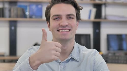 Young Adult Smiling and Giving Thumbs Up
