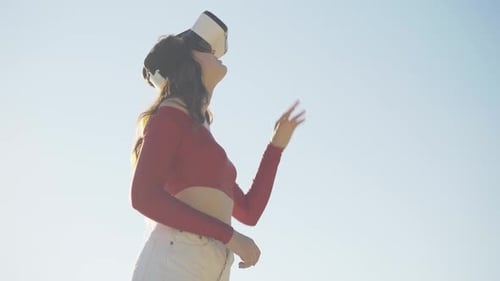 Woman Using Virtual Reality Headset in Sunny Urban Setting