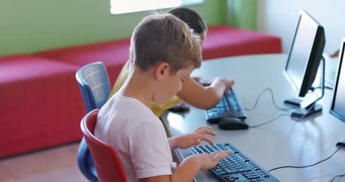 School kids using computer in classroom