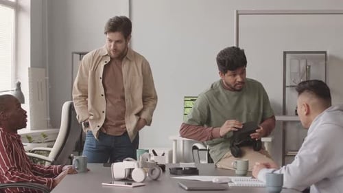 Diverse Programmers Discussing Video Game Development