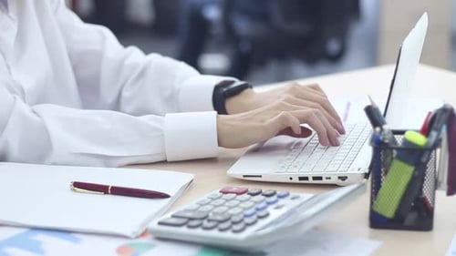 Business Woman Working With A Laptop And A Smart Watch At Office