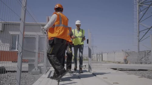 Engineers Examining Electricity Generator on Power Station