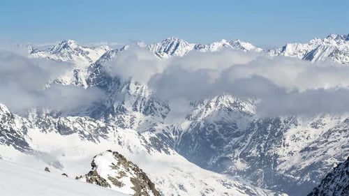 Snowy Mountains and Clouds on Sunny Day