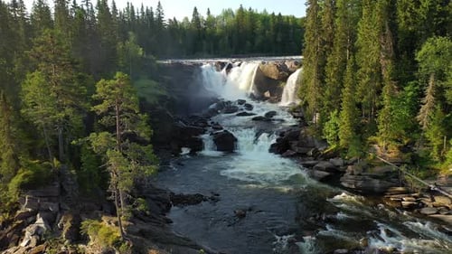 Aerial View of Waterfall Flowing Through Forest