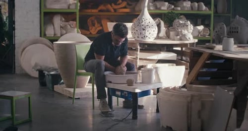 Male Artisan Creating Earthenware on Wheel