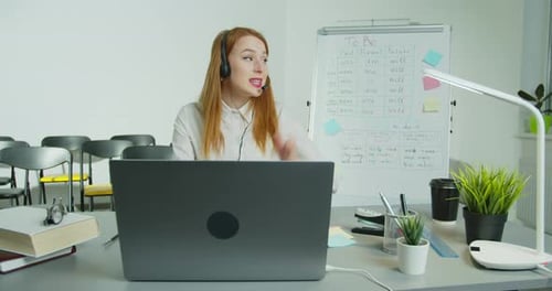 Teacher Explains Lesson Online with Technology and Headset