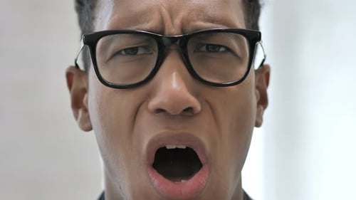 Close Up of Shocked Face of African Businessman, Astonished By Loss