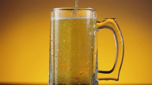 Beer Being Poured into a Glass Mug