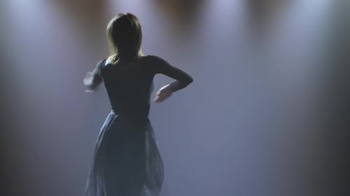 Woman Dancing Modern Dance at Smoky Stage with Spotlights. Vogue or Contemporary Dance. Young Dancer