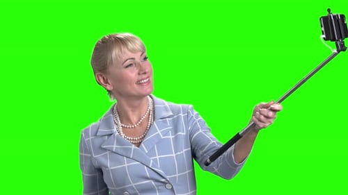 Woman with Selfie Stick on Green Screen