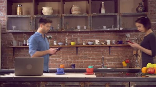 Young Adults Sharing Content on Tablet in Kitchen