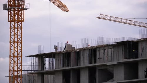Builders on the Edge of a Skyscraper Under Construction, Workers at a Construction Site