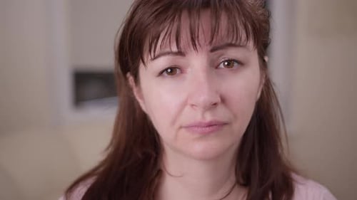 Close Up of a Woman with Pitying Eyes Looking at the Camera Moving Camera