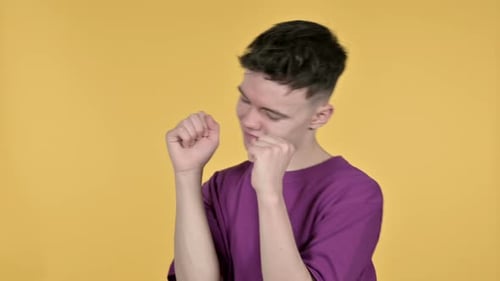 Enthusiastic Young Adult Dancing on Yellow Background