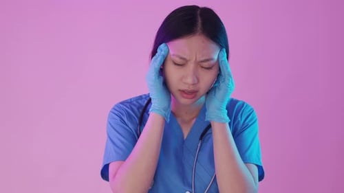 Frustrated Medical Professional with Headache