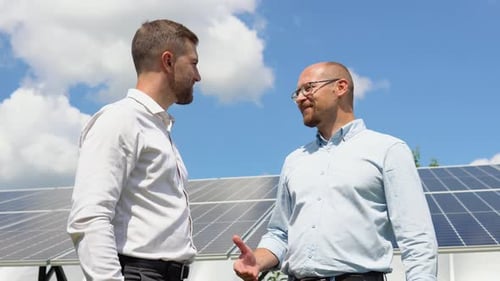 Two Workers Check the Installed Solar Panels