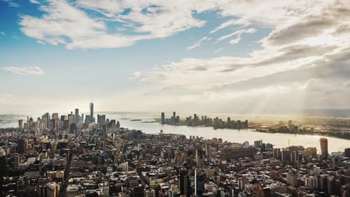 Beautiful Clouds with Rays of Sun Over New York City Business District