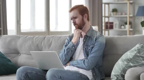 Pensive Creative Beard Man Thinking and Working on Laptop