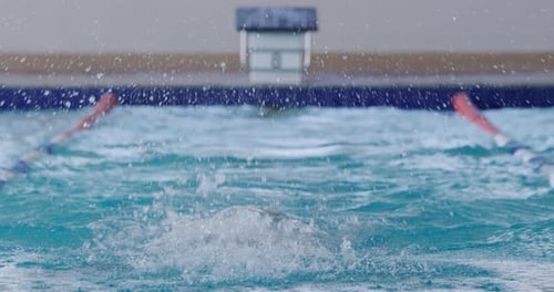 Swimmer swimming into the pool