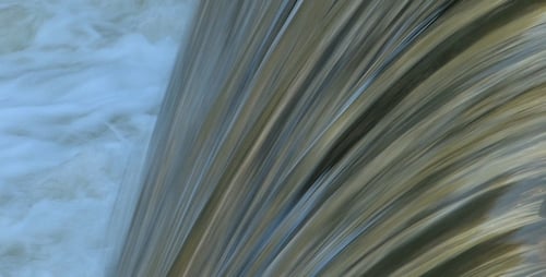 Beautiful Waterfall Flowing Over Rocks in Nature