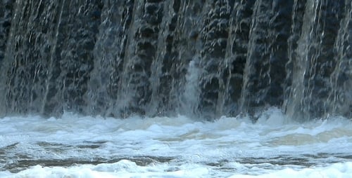 Flowing Water Cascading Down a Waterfall Structure