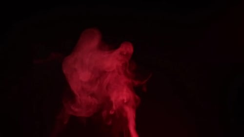 Red smoke, fog, mist, vapor on a black background.