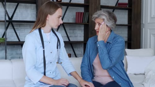 Doctor Talking To a Elderly Woman Patient at Medical Office in Hospital. Healthcare and People