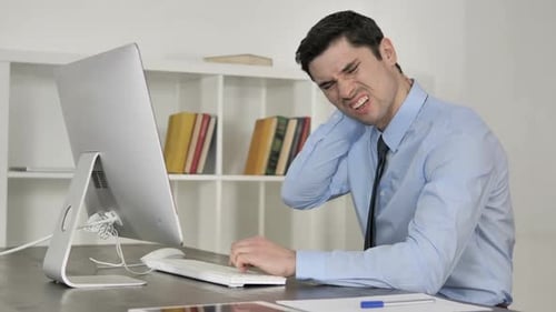 Businessman with Neck Pain Working on Computer