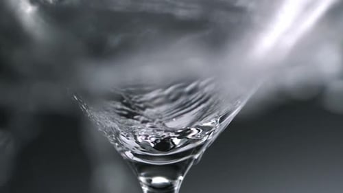 Clear Liquid Filling Martini Glass in Close Up Shot