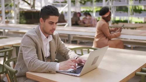 Sequence of Businessman Working on Laptop in Cafe