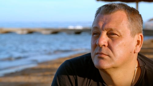 Handsome Middle-Aged Man Thinking At Beach