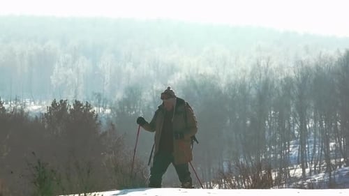 Adult Hiker Trekking on Snowy Winter Hill