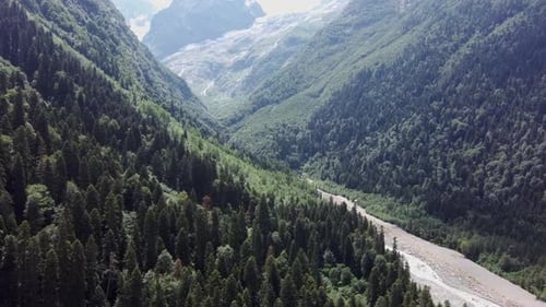 Aerial View of Mountain Forests Between River on Sunny Weather