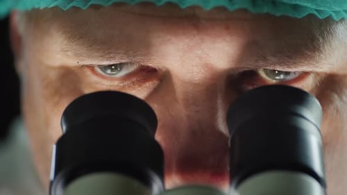 Portrait of a Scientist Working with a Microscope in the Lab