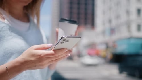 Successful Young Woman with Smartphone and Coffee Cup Business Buildings Street