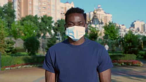Young Adult Wearing Face Mask in City Park
