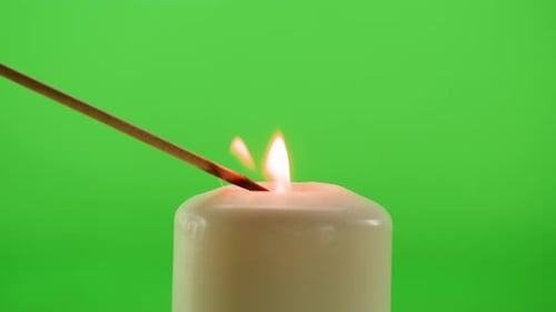 Burning Wax Candle on Green Chroma Key Background