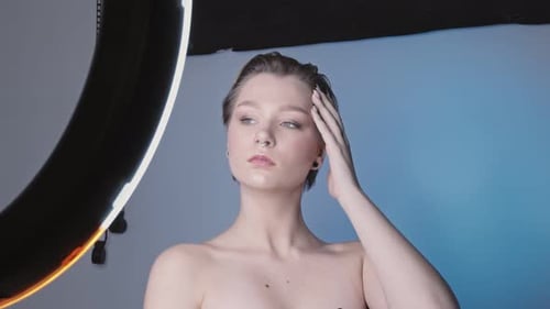 Young Beautiful Model Posing for Professional Photographer in Studio