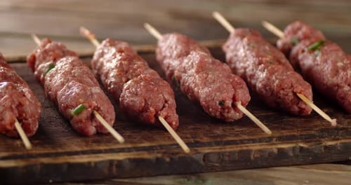 Raw Sausages on a Stick Slowly Rotate