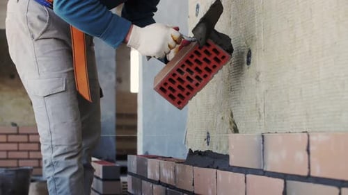 close-up bricklaying, builder's hands, footage of construction