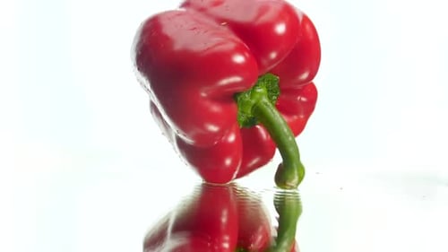 Fresh Red Bell Pepper on Reflective Surface