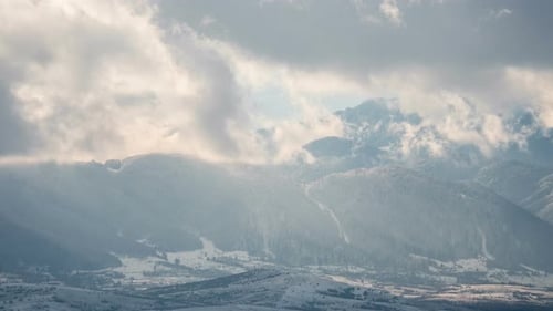 Timelapse of clouds over mountains on a winter day