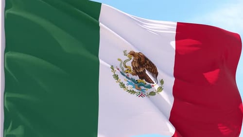 Mexican Flag Waving in the Wind with Blue Sky Background