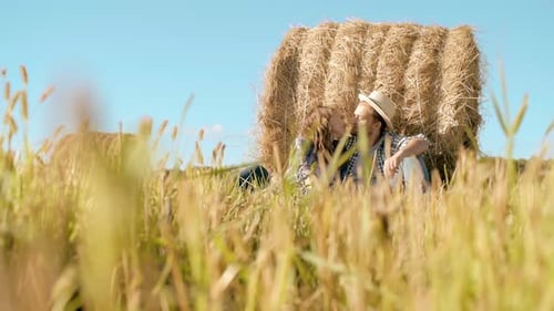 Romantic Young Couple Kissing Near Hay Bale