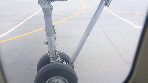 Close View of Airplane Landing Gear Moving on Tarmac