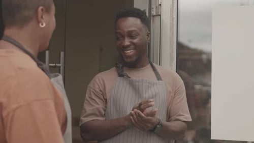 Waiters Chatting at Restaurant Door