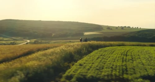 Travelers Walk on Hilly Terrain a Man Gestures the Terrain